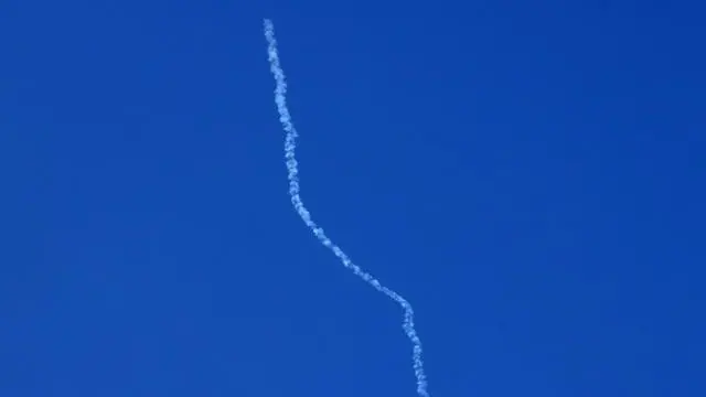 epa12187543 The trail of an Iranian missile launched towards Israel, as seen from the West Bank village of Yabad, near Jenin, 20 June 2025. EPA/ALAA BADARNEH