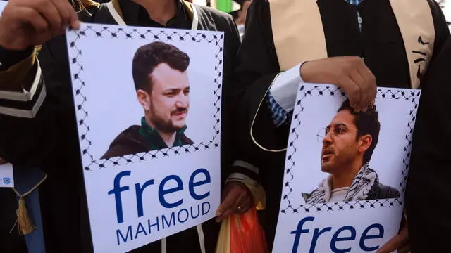 epa12054877 Houthi supporters in graduation attire hold placards featuring detained Columbia University students Mahmoud Khalil and Mohsen Mahdawi, during a protest against the United States, in Sana'a, Yemen, 25 April 2025. Thousands of Houthi supporters took to the streets of Sana'a to protest against US airstrikes targeting several Yemeni cities since mid-March. The Houthis have launched several attacks with more than 20 drones and missiles against US military vessels in the Red Sea and shot down three US Army MQ-9 Reaper drones over Yemen in the last week, Houthi leader Abdul-Malik al-Houthi said in a televised speech. EPA/YAHYA ARHAB
