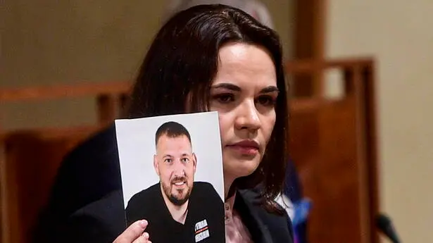 epa09641404 (FILE) - Belarusian opposition leader Svetlana Tikhanovskaya holds a picture of her husband, jailed opposition figure and blogger Sergei Tikhanovsky, as she addresses the Czech Senate in Prague, Czech Republic, 09 June 2021 (reissued 14 December 2021). On 14 December 2021, a court in Belarus sentenced opposition leader Sergei Tikhanovsky to 18 years in prison. He had been detained in 2020 and accused of inciting riots, among other charges, as unprecedented protests against disputed leader Lukashenko erupted after the 2020 election. Tikhanovsky's wife, self-exiled leader Svetlana Tikhanovskaya, denounced the verdict. EPA/ROMAN VONDROUS / POOL