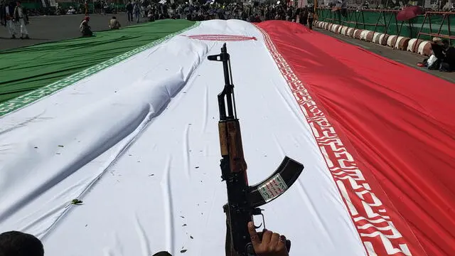 epa12187468 Houthi supporters gather around an Iranian flag during a protest against the Israeli airstrikes on Iran, in Sana'a, Yemen, 20 June 2025. Thousands of Houthi supporters demonstrated in Sana'a in solidarity with the Iranian people amid the recent military escalation between Israel and Iran. Houthi leader Abdul-Malik al-Houthi has pledged, in a televised speech, full support for Iran and Gaza in response to the Israeli military operations, vowing that his group’s missile attacks against Israel, including maritime actions, would continue. EPA/YAHYA ARHAB