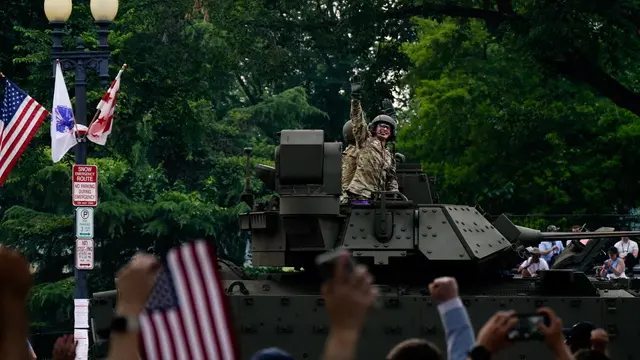 epa12176201 A member of the military waves from a tank during the US Army's 250th Anniversary Parade in Washington, DC, USA, 14 June 2025. The parade, which happens to coincide with US President Donald Trump’s 79th birthday, is expected to cost up to $45 million and feature 6,600 soldiers, 50 helicopters and 60-ton M1 Abrams battle tanks. EPA/KENT NISHIMURA / POOL