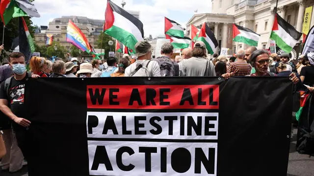 epa12192599 People take part in a demonstration in support of Palestine Action in Trafalgar Square, London, Britain, 23 June 2025. The British government is preparing to ban Palestine Action following the vandalism of two planes at an RAF base, which would make it a criminal offence to belong to or support the group. EPA/NEIL HALL