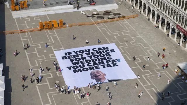 epa12192418 A handout photo made available by Greenpeace press office shows activists of the environmental group Greenpeace unfolding a giant banner with the image of US businessman and Amazon founder Jeff Bezos, and a slogan reading 'If you can rent Venice for your wedding you can pay more tax' at St Mark's Square in Venice, Italy, 23 June 2025. Venice will host the wedding of Jeff Bezos and his fiancee journalist Lauren Sanchez in June 2025. EPA/GREENPEACE PRESS OFFICE HANDOUT HANDOUT EDITORIAL USE ONLY/NO SALES