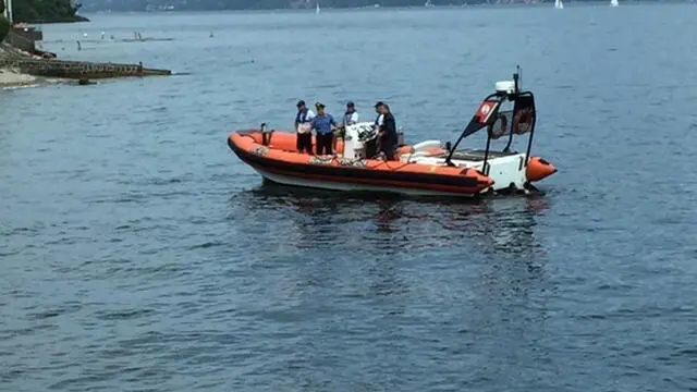 Un imbarcazione della Guardia Costiera nelle acque del Lago Maggiore dove uno straniero di venti anni è morto annegato, probabilmente colpito da un malore, 18 Luglio 2015. ANSA/ RENATO BALDUCCI