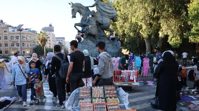epa12153528 People walk past roadside vendors ahead of the upcoming Muslim holiday of Eid al-Adha, in Damascus, Syria, 03 June 2025. Eid al-Adha, the holiest of the two annual Muslim holidays, marks the yearly pilgrimage (Hajj) to Mecca. Muslims slaughter a sacrificial animal and split the meat into three parts: for family, friends, and the poor. EPA/MOHAMMED AL RIFAI