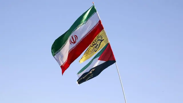 epa10982673 Protesters wave Iran and Palestinian flags together during an anti-Israeli rally to show their solidarity with the people of Gaza at Enghelab Square in Tehran, Iran, 18 November 2023. Thousands of Israelis and Palestinians have died since the militant group Hamas launched an unprecedented attack on Israel from the Gaza Strip on 07 October 2023 and the Israeli strikes on the Palestinian enclave that followed it. EPA/ABEDIN TAHERKENAREH