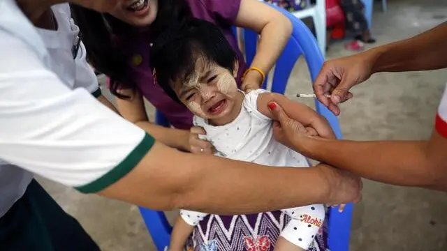 epa08026202 A girl cries as a medical worker from the Myanmar public health department is inoculated for measles and rubella during a nationwide vaccination campaign, at Lanmadaw in Yangon, Myanmar, 26 November 2019. The three-day campaign is expected to cover 95 percent of children between the ages of nine months to five and half-years-old. The campaign is aimed at reduce mortality rates of children under the age of five and the country wide eradication of measles and rubella by 2023. EPA/LYNN BO BO