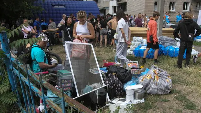 epa12195348 A handout photo made available by the Dnipropetrovsk Regional Military Administration shows local people sitting with their belongings near a damaged residential building following massive Russian shelling in the city of Dnipro, Ukraine, 24 June 2025. At least 16 people died and 279 were injured in Dnipro and the Dnipropetrovsk area after the Russian rocket attack in the region, where a dormitory, gymnasium, administration building, and a passenger train were damaged, according to the head of the Dnipropetrovsk Regional Military Administration, Sergii Lysak. EPA/Dnipropetrovsk Regional Military Administration handout HANDOUT HANDOUT EDITORIAL USE ONLY/NO SALES