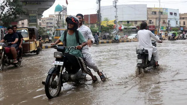 epa12202892 People ride motorcycle amid rainfall in Karachi, Pakistan, 28 June 2025. Heavy monsoon rains have impacted major cities across Pakistan, including Islamabad, Lahore, Hyderabad and Karachi, triggering urban flooding and power outages. Authorities remain on high alert. EPA/REHAN KHAN 89518