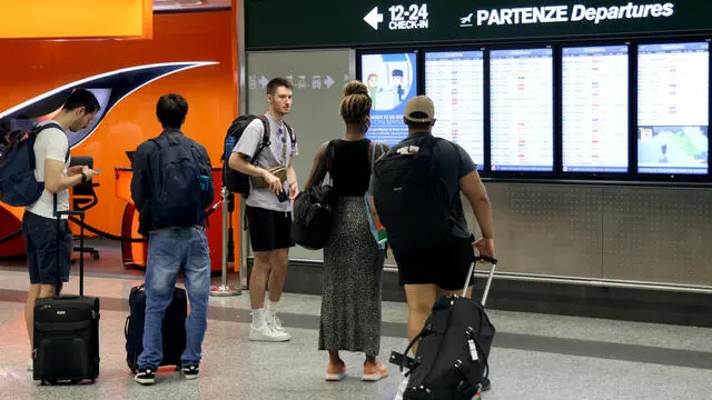 Alcuni passeggeri controllano i monitor che indicano i voli in partenza all’aeroporto di Milano Malpensa. Diversi voli sono in ritardo o sono stati cancellati a causa di uno sciopero di 24 ore nel settore del trasporto aereo. Milano 8 Settembre 2023. ANSA / MATTEO BAZZI