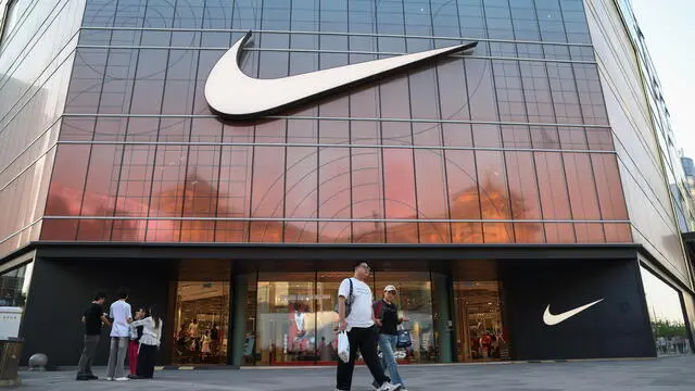 epa12099295 People walk past a Nike store in Beijing, China, 14 May 2025. After a tariff truce between the U.S. and China was agreed upon on 12 May, the U.S. will lower its maximum tariff rate on Chinese imports from 145 percent to 30 percent, with a 10 percent baseline levy plus a fentanyl-specific 20 percent levy. China will cut its 125 percent tariff on American goods to 10 percent, starting 14 May. EPA/WU HAO