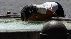 People cool off in a fountain during a heatwave, in Rome, Italy, 28 June 2025. ANSA/ANGELO CARCONI