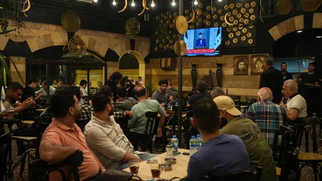 epa12100752 Syrians watch a speech by Syrian President Ahmad al-Sharaa, after Trump's decision to lift sanctions on Syria, at Al-Rawda Cafe in central Damascus, Syria, 14 May 2025. EPA/AHMAD FALLAHA