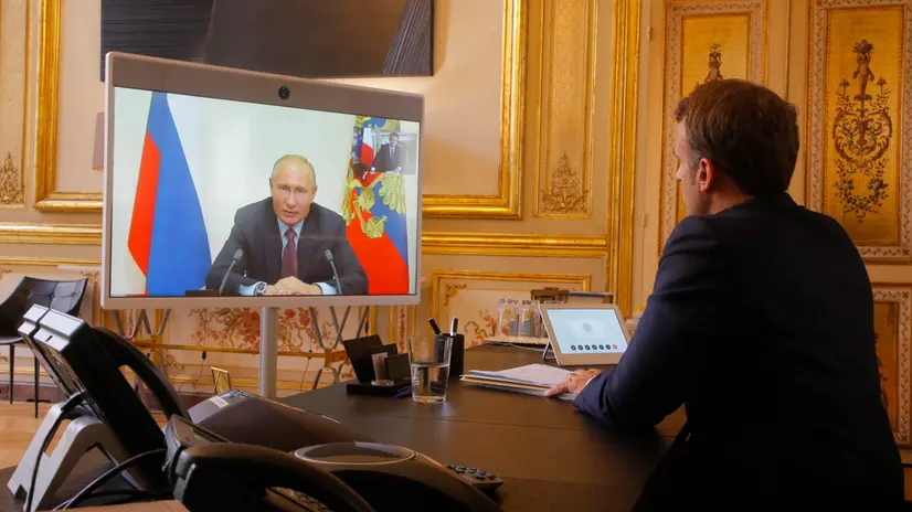 epa08510702 French President Emmanuel Macron listens to Russian President Vladimir Putin during a video at the Elysee Palace in Paris, France, 26 June 2020. Russian President Vladimir Putin holds video talks with French President Emmanuel Macron about the virus, Libya, Syria and relations with the U.S. under Donald Trump. EPA/Michel Euler / POOL MAXPPP OUT