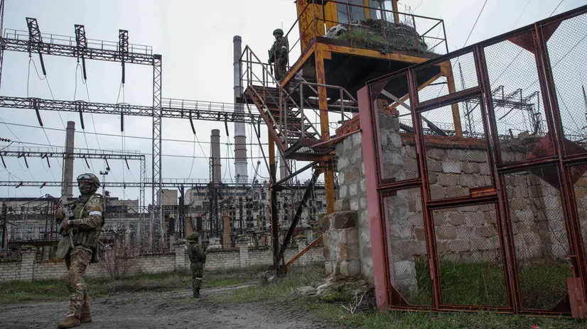 epa09888262 A picture taken during a visit to Shchastia organized by the Russian military shows Russian servicemen guard on the entrance of the Luhansk Power Station in Luhansk region, in Shchastia, Luhansk region, Ukraine, 13 April 2022. Stopped by the Ukrainian side a few days before the start of the Russian special operation, the station provided electricity to more than a million people. The Ukrainian Armed Forces mined the object during the retreat, and some high-voltage power lines were damaged during the fighting. The station is a strategic and important energy facility of the self-proclaimed Luhansk People's Republic. After the start of operation of the station, it will be possible to start production at the metallurgical enterprises of the republic, which was stopped in 2014, when the station was cut off from the energy system of Lugansk. On 24 February Russian troops had entered Ukrainian territory in what the Russian president declared a 'special military operation', resulting in fighting and destruction in the country, a huge flow of refugees, and multiple sanctions against Russia. EPA/SERGEI ILNITSKY