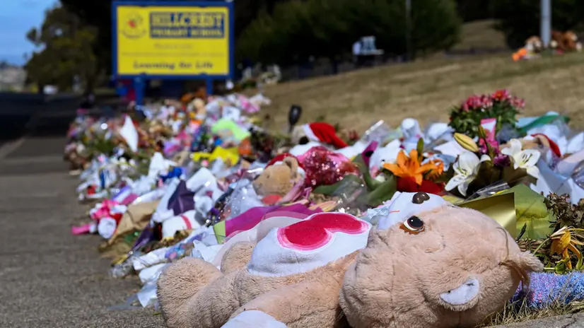 epaselect epa09654649 Flowers, soft toys and tributes are seen outside Hillcrest Primary School in Devonport, Tasmania, Australia, 23 December 2021. Six children were killed at a primary school in Tasmania's northwest last week, after a freak accident saw a jumping castle being picked up an estimated 10 metres by a powerful gust of wind. EPA/BIANCA DE MARCHI AUSTRALIA AND NEW ZEALAND OUT