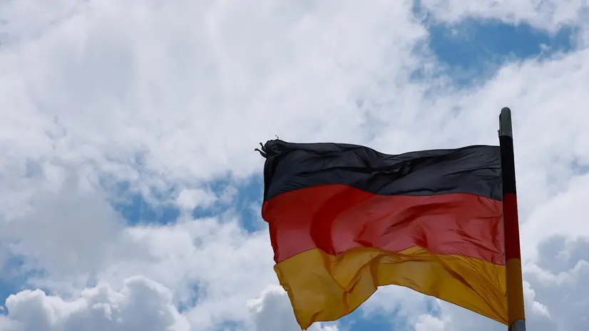 epa12196630 A German flag is seen during a session of the German parliament 'the Bundestag' in Berlin, Germany, 25 June 2025. EPA/HANNIBAL HANSCHKE