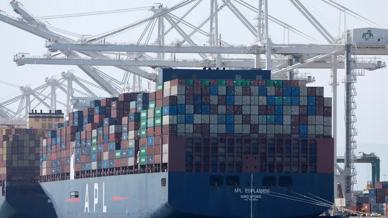 epa12156380 A sailboat passes by a container ship at the Port of Oakland in Oakland, California, USA, 04 June 2025. According to the Port of Oakland, container volume dropped 14.7 percent in April 2025, primarily due to market uncertainty and the impact of tariffs. The slowdown in shipping activity is raising concerns about job stability and and the regionâ€™s economic health. EPA/JOHN G. MABANGLO