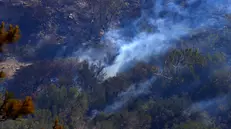 epa12212221 Scattered blazes burn in the forest during a wildfire in Ierapetra, on Crete island, Greece, 03 July 2025. According to Fire Department spokesperson Chief Vasilios Vathrakoyannis, 230 firefighters with 13 foot teams, 46 vehicles, and 10 helicopters are battling multiple wildfire outbreaks in Ierapetra, Crete, after the fire broke out on the afternoon of 02 July. Strong winds reaching 9 Beaufort continue to spark new blazes and smog, complicating efforts. Water tankers and machinery from Crete, Central Macedonia, and the General Staff of National Defense are also assisting. EPA/NIKOS CHALKIADAKIS