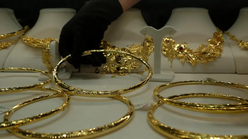 epa11269009 A saleswoman picks up a gold item at a jewelry shop in Hanoi, Vietnam, 10 April 2024. The price of gold in Vietnam has soared to record high price recently. Vietnamese Prime Minister Pham Minh Chinh ordered the central bank to take measures to stabilize the market and narrow the price gap between the international and domestic gold rate. EPA/LUONG THAI LINH