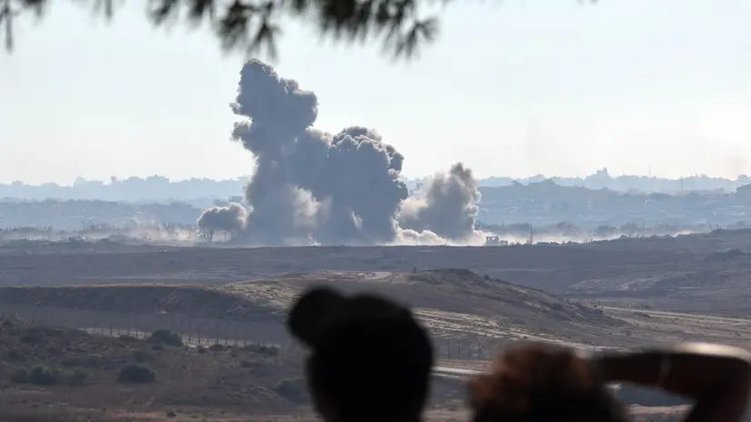 epa12213110 Israelis watch smoke rise from north Gaza near Beit Hanoun as seen from the Israeli side of the border, 03 July 2025. EPA/ATEF SAFADI