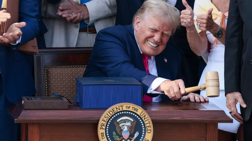 epaselect epa12216702 US President Donald J. Trump, with the gavel Speaker of the House Mike Johnson gave him, after signing his 'Big Beautiful Bill' into law during the Independence Day Military Family Picnic on the South Lawn of the White House in Washington, DC, USA 04 July 2025. The Independence Day festivities also include President Trump signing his 'Big Beautiful Bill' into law, military flyovers and the annual fireworks display on the National Mall. EPA/SHAWN THEW