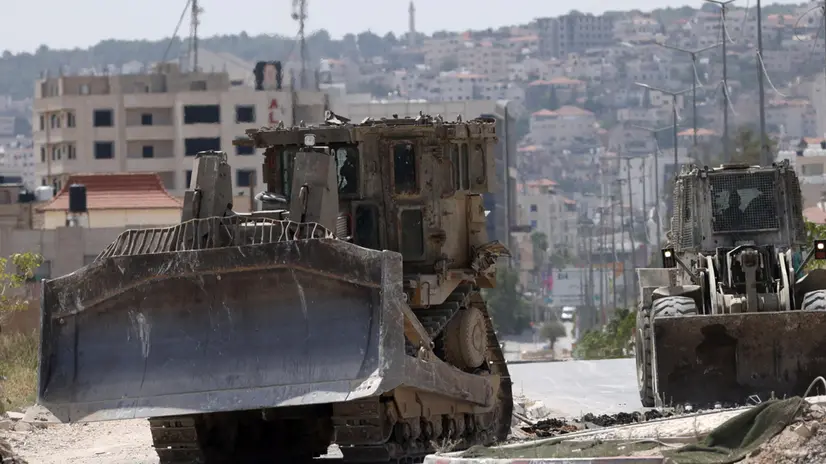 epa11458475 Israeli military bulldozers during an Israeli military operation in the West Bank city of Jenin, 05 July 2024. At least six people have been killed as a result of Israel's military operation in Jenin and its refugee camp, the Palestinian Ministry of Health said. The Israeli military stated that its forces were conducting 'counterterrorism activity' in the area of Jenin. EPA/ALAA BADARNEH