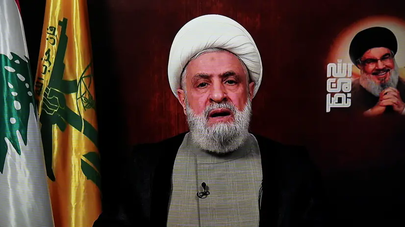 epa11748235 A photo of a TV screen shows Hezbollah leader Sheikh Naim Qassem delivering a televised speech broadcasted on Hezbollah's al-Manar TV channel, in Beirut, Lebanon, 29 November 2024. A 60-day ceasefire agreement between Israel and Hezbollah came into force on 27 November. EPA/WAEL HAMZEH