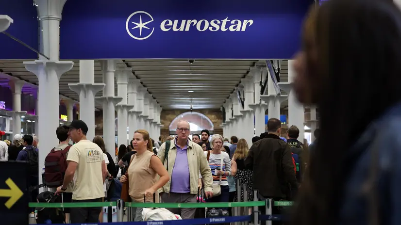 epa11497101 Rail passengers queue up at Eurostar rail terminal at St. Pancras International station in London, Britain, 26 July 2024. Eurostar has cancelled some trains from London to Paris due to arson attacks on the French rail network. Cancellations may continue into the weekend. France's high speed rail network TGV was severely disrupted on 26 July following a 'massive attack', according to French train operator SNCF, just hours before the opening ceremony of the Paris 2024 Olympic games. EPA/ANDY RAIN