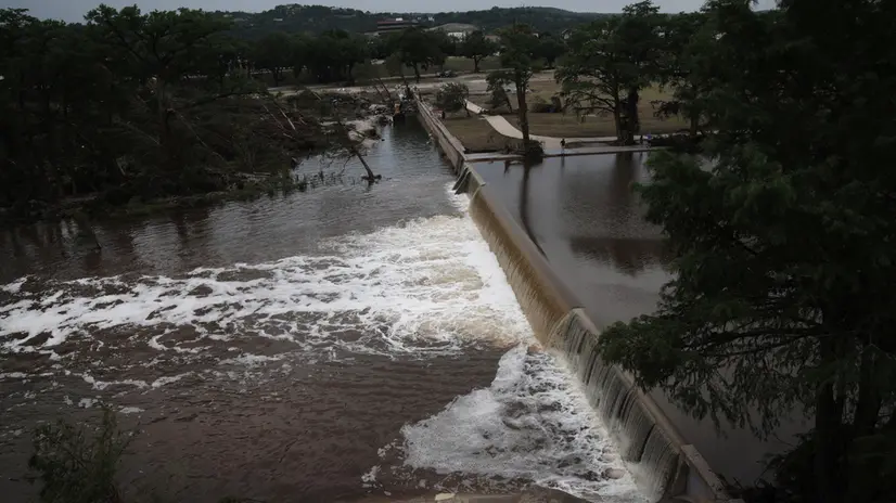 epa12221450 Water spills over the Kerville dam, Texas, USA, 06 July 2025. At least 69 people have been killed after floodwaters swept through a summer camp and nearby homes on early 04 July. EPA/DUSTIN SAFRANEK