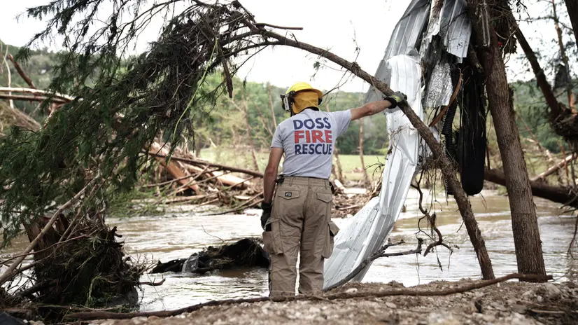 epa12223197 A first responder rests near a search area along that Guadalupe river near Blue Oak RV Park in Ingram, Texas, USA, 07 July 2025. At least 91 people have been killed in floods in central Texas, the White House preess secretary said on 07 July. At least 27 of them died when floodwaters swept through a summer camp and nearby homes on early 04 July. EPA/DUSTIN SAFRANEK