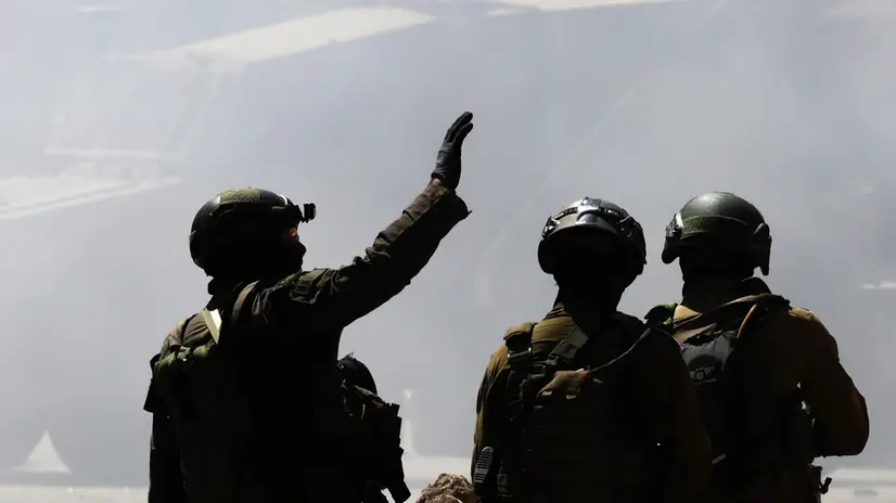 epaselect epa12183492 Israeli soldiers check the area after demolishing a store with explosives during a military operation in the Balata refugee camp, near the West Bank city of Nablus, 18 June 2025. According to the Palestinian Health Ministry, at least 20 Palestinians were wounded during the operation. EPA/ALAA BADARNEH