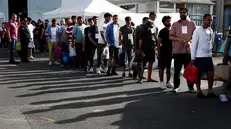 epa10694273 Migrants walk toward a bus that will take them from Kalamata port to a migrant reception facility in Malakasa, Greece, 16 June 2023. The 104 people rescued after a migrant boat capsized off the coast of Pylos will be taken to a migrant reception facility in Malakasa. A total of 104 individuals were rescued, while 78 bodies were recovered, after a fishing boat capsized in international waters 47 nautical miles southwest of the Peloponnese coast and the town of Pylos. The number of people missing remains unknown. EPA/YANNIS KOLESIDIS