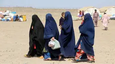 epaselect epa12040494 Afghan migrants walk through a tent camp after returning from neighboring Pakistan, in Spin Boldak District, Kandahar, Afghanistan, 19 April 2025. The Taliban government of Afghanistan has condemned Pakistanâ€™s forced expulsion of Afghan migrants, calling it against Islamic principles and international norms. It has urged the UN to intervene as a mass deportation campaign, affecting 800,000 Afghan nationals, began on 01 April. EPA/QUDRATULLAH RAZWAN