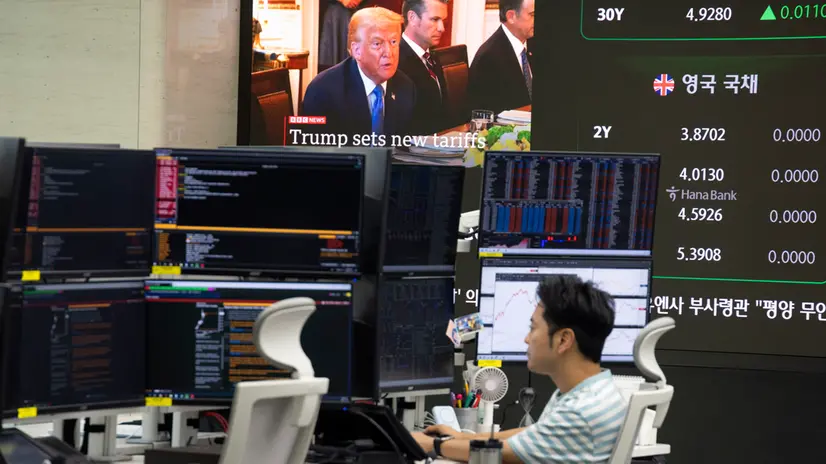 epa12223767 A South Korean dealer works in front of monitors at the Hana Bank in Seoul, South Korea, 08 July 2025. The benchmark South Korea Composite Stock Price Index (KOSPI) rose 55.48 points, or 1.81 percent, to close at 3,114.95. U.S. President Donald Trump announced on 07 July that the US will impose a new tariff rate of 25 percent on South Korea starting 01 August. EPA/JEON HEON-KYUN