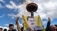 epa11978438 Supporters of The Peoples' Equality and Democracy Party (DEM) hold pictures of Kurdistan Workers' Party (PKK) jailed leader Abdullah Ocalan, and shout slogans next to a bonfire during a rally for Newruz celebrations in Diyarbakir, Turkey, 21 March 2025. Newroz or Nowruz, which means 'new day' in the Persian language, marks the arrival of spring and the first day in the Iranian calendar. It is widely celebrated in the Persian and neighboring regions and recognized on the UNESCO List of the Intangible Cultural Heritage of Humanity. EPA/METIN YOKSU