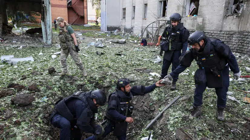 epa12221778 Ukrainian experts work at the site of a drone strike on a residential building in Kharkiv, northeastern Ukraine, 07 July 2025, amid the Russian invasion. According to the State Emergency Service (SES), at least 29 people were injured, including three children, following a Russian attack by shock drones on Kharkiv and its suburbs. EPA/SERGEY KOZLOV