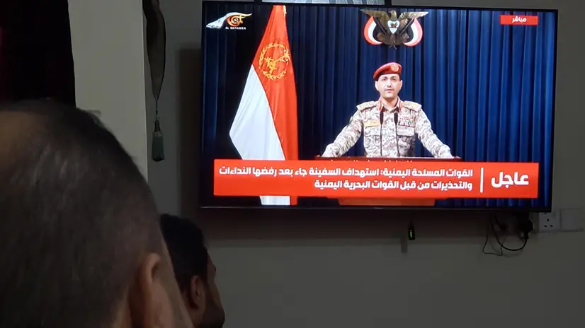 epa12227204 People watch Houthi military spokesman Yahya Sarea delivering a TV statement on the attack on the Eternity C ship, in Sana'a, Yemen, 09 July 2025. Yemen's Houthis have claimed attacking and sinking the Eternity C ship in the Red Sea, according to a statement by Houthi military spokesman Yahya Sarea. EPA/YAHYA ARHAB