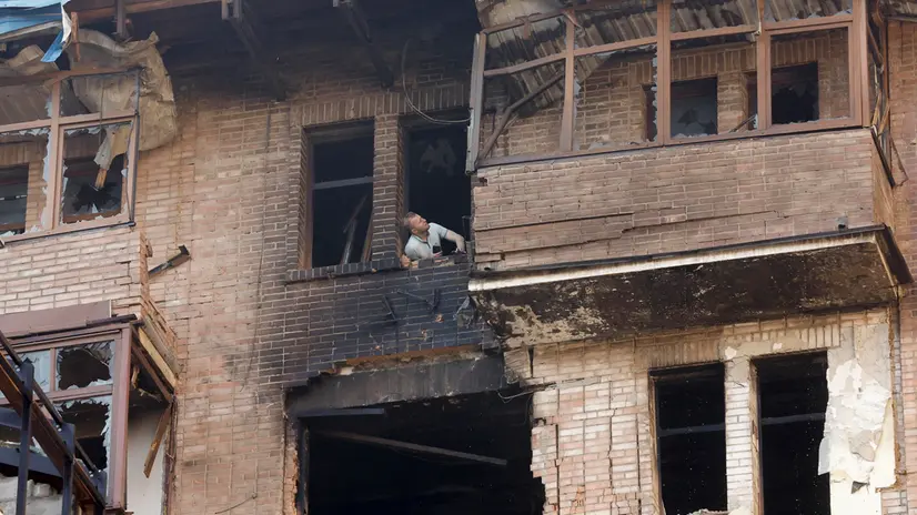 epa12228455 A man looks out of a broken window at the site of a drone strike in Kyiv, Ukraine, 10 July 2025, amid the ongoing Russian invasion. At least two people were killed in Kyiv, and many others were injured across Ukraine, following overnight Russian strikes in the Kyiv, Chernihiv, Sumy, Poltava, Kirovohrad and Kharkiv regions, the State Emergency Service confirmed. EPA/SERGEY DOLZHENKO