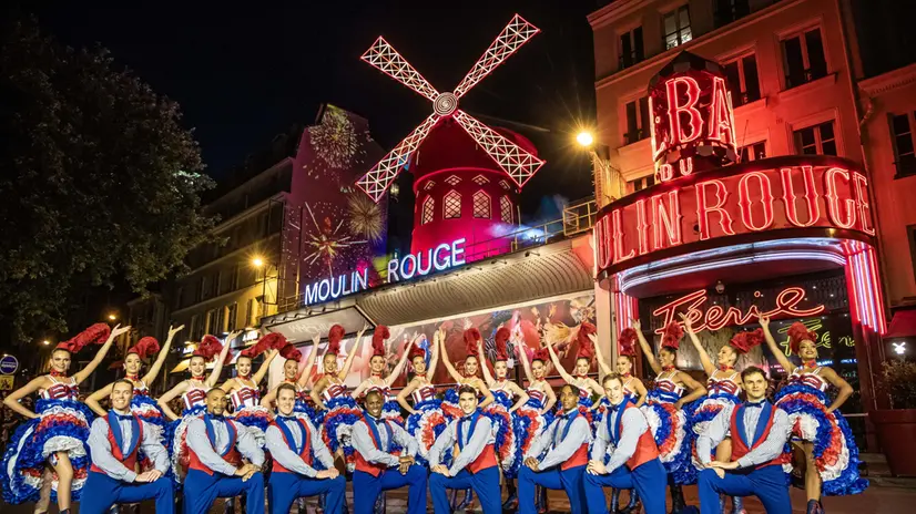 epa11461247 French Moulin Rouge venue dancers perform a French Can-Can dance outside Parisian famous Cabaret in Paris, France, 05 July 2024 as part of the inauguration of its new windmill blades. The windmill blades on the facade of the famous Moulin-Rouge cabaret broke off during the night of 25 April 2024. EPA/CHRISTOPHE PETIT TESSON