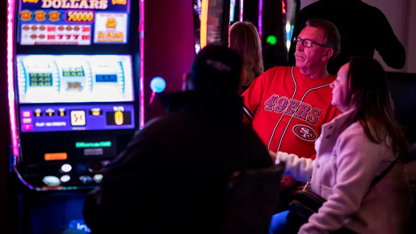 epaselect epa11143941 An American football supporter plays a slot machine in Mandalay Bay Hotel and Casino in Las Vegas, Nevada, USA, 10 February 2024. The AFC champion Kansas City Chiefs will face the NFC champion San Francisco 49ers in Super Bowl LVIII at State Allegiant Stadium in Las Vegas, Nevada, on 11 February 2024. EPA/ETIENNE LAURENT