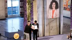 epa11021102 Ali and Kiana Rahmani receive from leader of the Nobel Committee Berit Reiss-Andersen (L), on behalf of their mother Narges Mohammadi, the Nobel Peace Prize for 2023 in Oslo City Hall, Norway, 10 December 2023. Iranian human rights activist and Nobel Peace Prize 2023 winner, Narges Mohammadi, is imprisoned and is therefore represented by her children Ali and Kiana Rahmani and husband Taghi Rahmani. Mohammadi receives the peace prize for her fight against the oppression of women in Iran and the fight for human rights and freedom for all. EPA/JAVAD PARSA NORWAY OUT