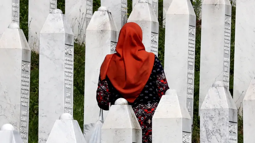epa12226439 (FILE) - A Bosnian Muslim woman visits gravestones during a funeral ceremony for thirty newly-identified Bosnian Muslim victims, at the Potocari Memorial Center and Cemetery, in Srebrenica, Bosnia and Herzegovina, 11 July 2023 (reissued 09 July 2025). The UN General Assembly designated 11 July as the International Day of Reflection and Commemoration for the 1995 Genocide in Srebrenica perpetrated by the Bosnian Serb army. The massacre led to the killing of at least 8,372 men and boys, the displacement of thousands, and the destruction of entire communities in Srebrenica, which had been designated a “safe area” by the UN Security Council. EPA/FEHIM DEMIR