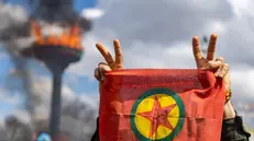 epa11978437 Supporters of The Peoples' Equality and Democracy Party (DEM) hold a flag of the Kurdistan Workers' Party (PKK), and shout slogans next to a bonfire during a rally for Newruz celebrations in Diyarbakir, Turkey, 21 March 2025. Newroz or Nowruz, which means 'new day' in the Persian language, marks the arrival of spring and the first day in the Iranian calendar. It is widely celebrated in the Persian and neighboring regions and recognized on the UNESCO List of the Intangible Cultural Heritage of Humanity. EPA/METIN YOKSU