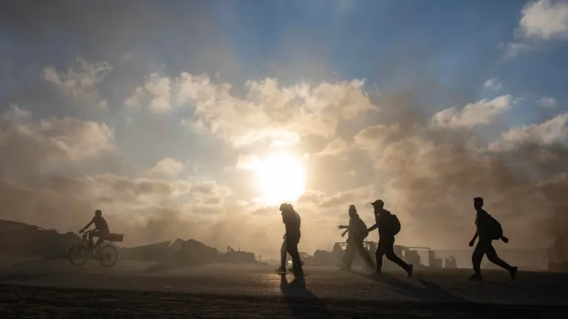 epa12213694 Palestinians head to gather to receive humanitarian aid to be delivered through the Netzarim Corridor in the central Gaza Strip, passing by a makeshift solar production point on Al-Rashid Street in western Gaza City, 03 July, 2025. EPA/HAITHAM IMAD