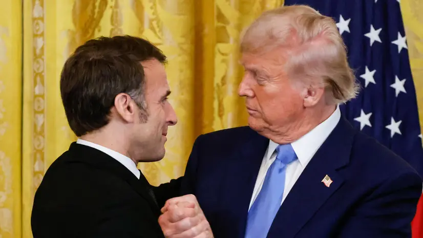 epa11922480 US President Donald Trump (R) and French President Emmanuel Macron (L) shake hands at the end of a joint press conference in the East Room to the White House in Washington, DC, USA, 24 February 2025. EPA/LUDOVIC MARIN / POOL