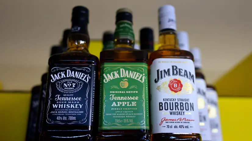 epa11963118 Whiskey and bourbon bottles sit on the shelf of a discount store in Berlin, Germany, 14 March 2025. US President Trump responded to the EU's planning for tariffs on American whiskey with an announcement on his online platform 'Truth Social', stating that the US will impose 200 percent tariffs on EU alcoholic beverages, if the Union does not withdraw its plan. EPA/HANNIBAL HANSCHKE