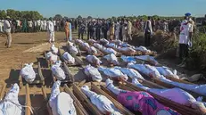 epa08851188 Nigerians attend a mass burial of farm workers killed in an attack at Zabarmari, Borno State, northeast Nigeria, 29 November 2020. According to reports, 43 farm workers in Zabarmari were killed by Boko Haram fighters in fields near Koshobe on 28 November 2020. The attackers tied up the farm workers and cut their throats in the village of Koshobe leaving many of them beheaded. EPA/STR