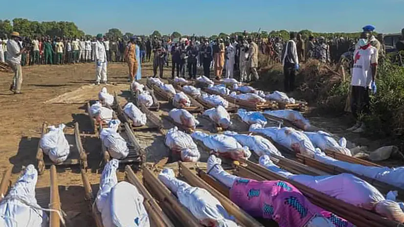 epa08851188 Nigerians attend a mass burial of farm workers killed in an attack at Zabarmari, Borno State, northeast Nigeria, 29 November 2020. According to reports, 43 farm workers in Zabarmari were killed by Boko Haram fighters in fields near Koshobe on 28 November 2020. The attackers tied up the farm workers and cut their throats in the village of Koshobe leaving many of them beheaded. EPA/STR