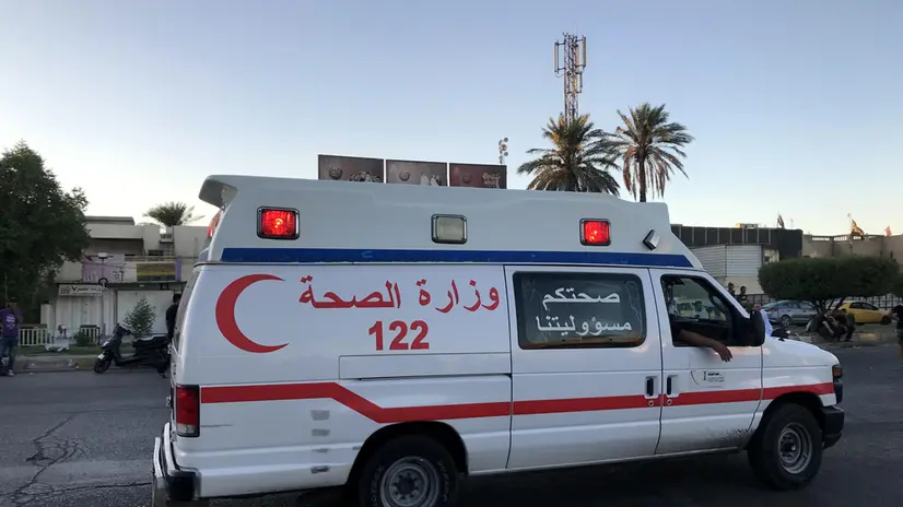 epa07904558 An Ambulance drives as Iraqi protesters take part in an anti-Iraq government protest in the al-Tayaran square in central Baghdad, Iraq, 04 October 2019 (issued on 07 October 2019). A wave of unrest and violent protests in Iraq have left at least 100 people dead and thousands injured. EPA/MURTAJA LATEEF